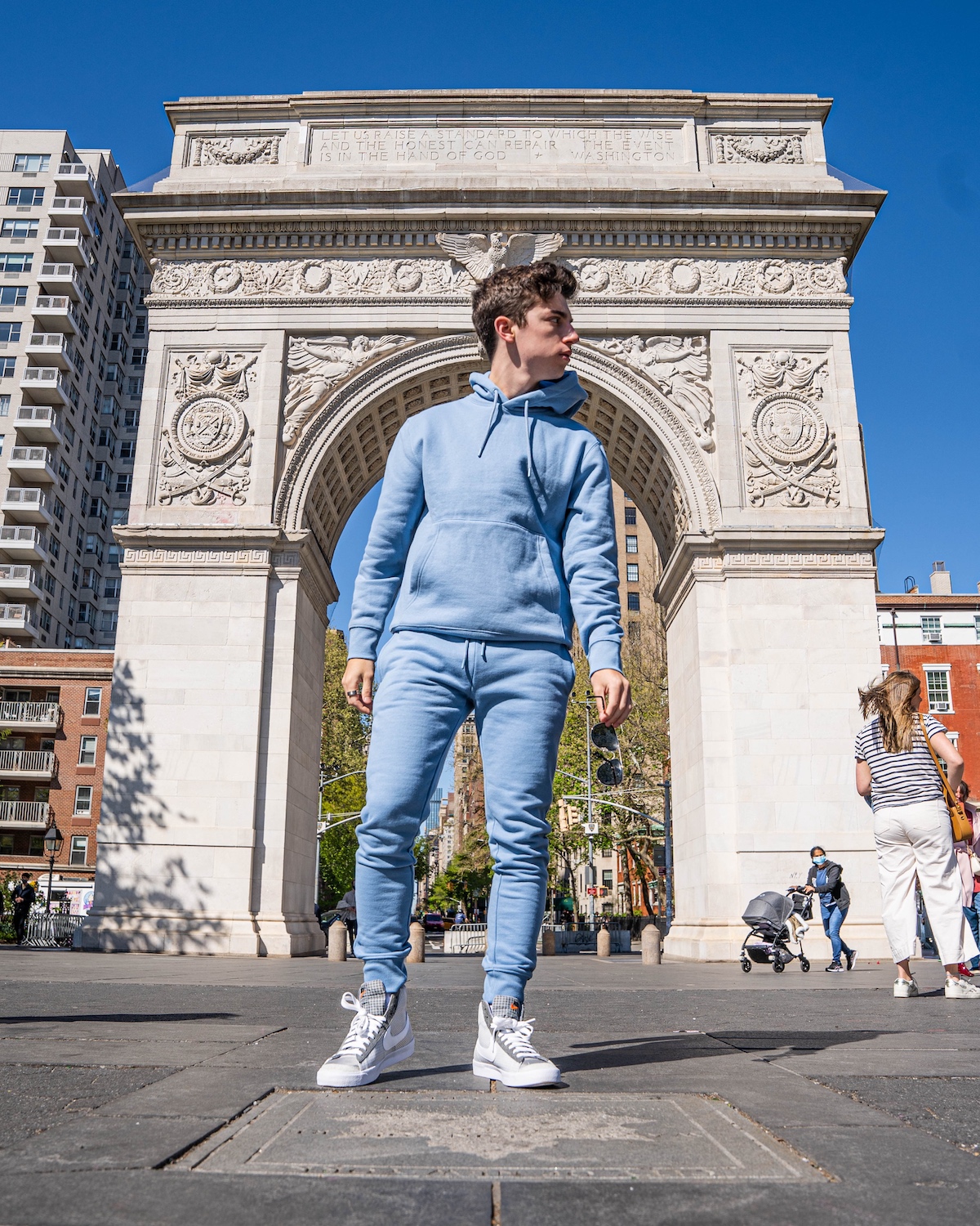 Eitan Bernath in a a blue sweatsuit in Washington Square Park NY.