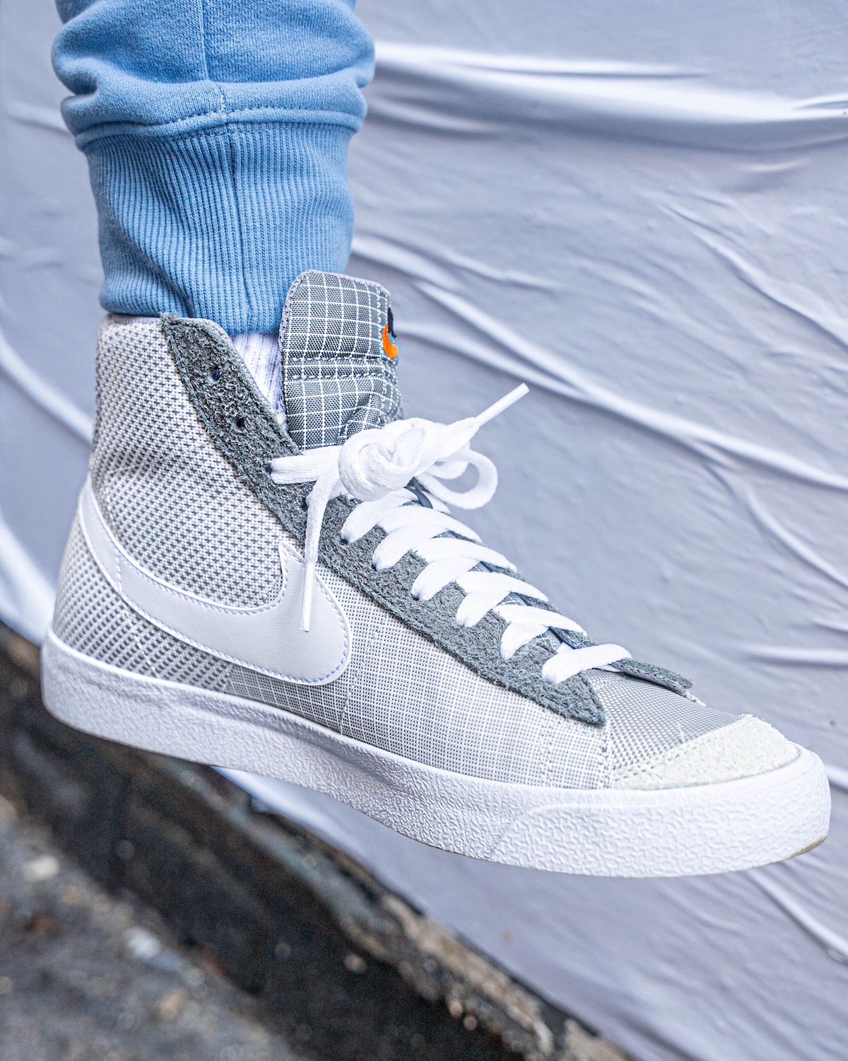 Eitan's Grey Nike blazer mid 77 patch high top sneakers.